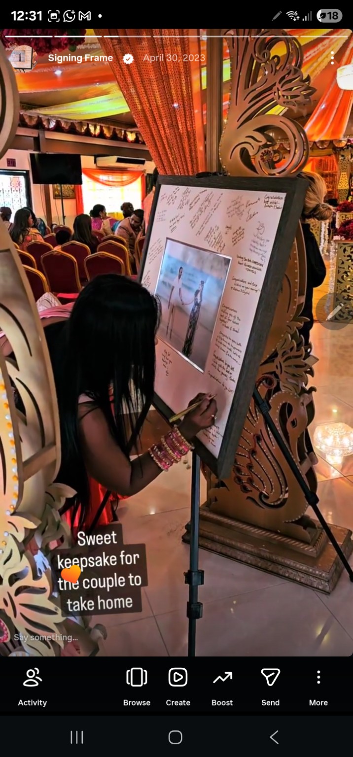 Wedding guest writing a message on a light signing border